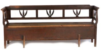 A Hungarian pine bench/settle, the slat back and sides above a hinged rectangular seat and square