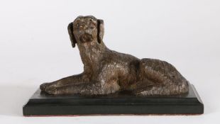 19th Century bronze dog, modelled in a laying position, on a black marble plinth base, 18cm wide,