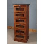 A Large 20th century haberdashery cabinet with a square top above six glazed drawers and a plinth