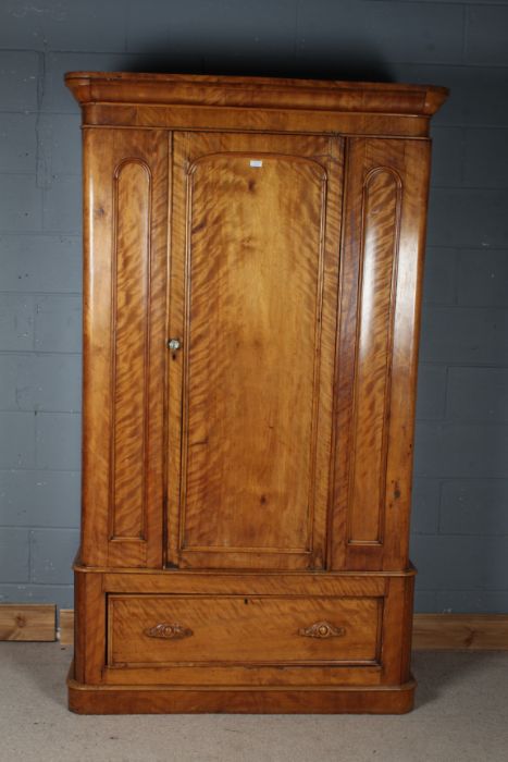 Victorian satin birch wardrobe, the moulded cornice above a single door enclosing two pull out rails