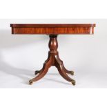 Regency mahogany games table, the rotating D shaped fold-over top with reeded rim, the frieze with