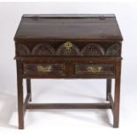 17th century desk/bible box on stand, the sloping fall with chip carved edge above a lunette