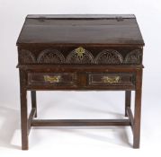17th century desk/bible box on stand, the sloping fall with chip carved edge above a lunette