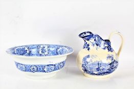 A 20th century blue and white transfer decorated wash bowl and jug, the jug is marked Minton the