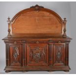 Victorian mahogany sideboard, the arched back with shield and foliate carved pediment and with