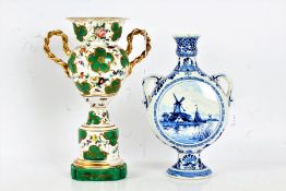 Delft pottery moon flask, painted with a canal and windmill to one side and flowers to the other,