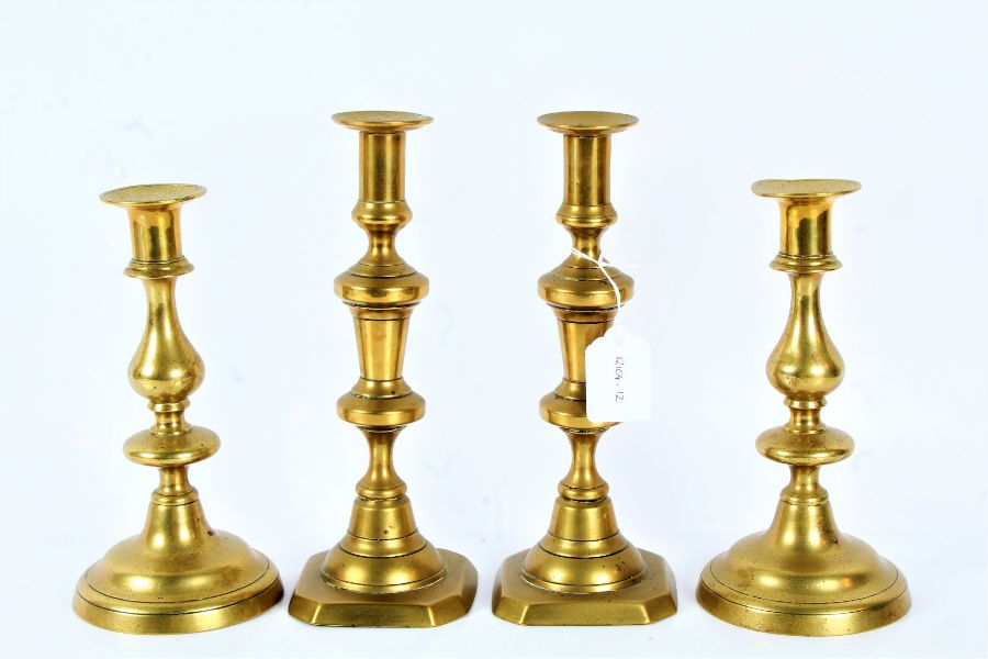 Two pairs of 19th century brass candlesticks, the tallest 24.cm (4)