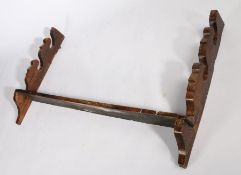 18th Century oak spit rack, the shaped sides above the shelf, 78.5cm high, 131cm wide