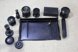 Ebony dressing table set, consisting of tray, pair of candlesticks, four pots and covers, pin