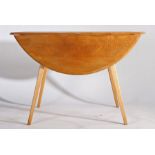 Ercol style drop leaf table, the circular top with two D shaped drop leaves, raised on tapering