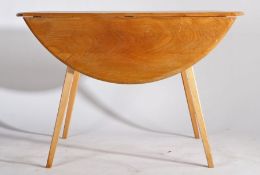 Ercol style drop leaf table, the circular top with two D shaped drop leaves, raised on tapering