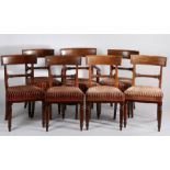 Seven Victorian mahogany dining chairs, the curved rectangular cresting rails above scroll carved