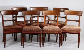 Seven Victorian mahogany dining chairs, the curved rectangular cresting rails above scroll carved