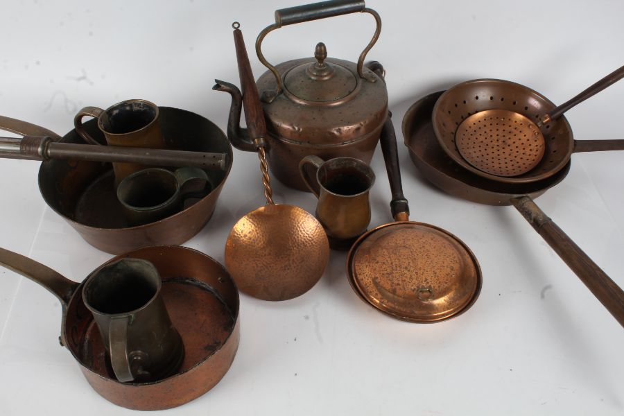 Collection of copper and brass ware to include a 20th century spot hammered ladle with a twisted