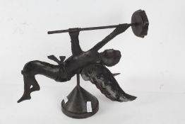 Iron wall sconce in the form of a cherub holding up a candlestick, 45cm high