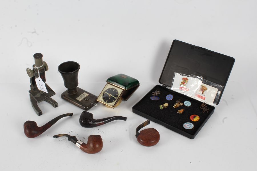 Works of art to include four pipes, Blessing West German travel clock, students microscope, pin