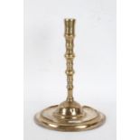 17th Century brass candlestick, circa 1660, the flared sconce above a knopped stem and dished