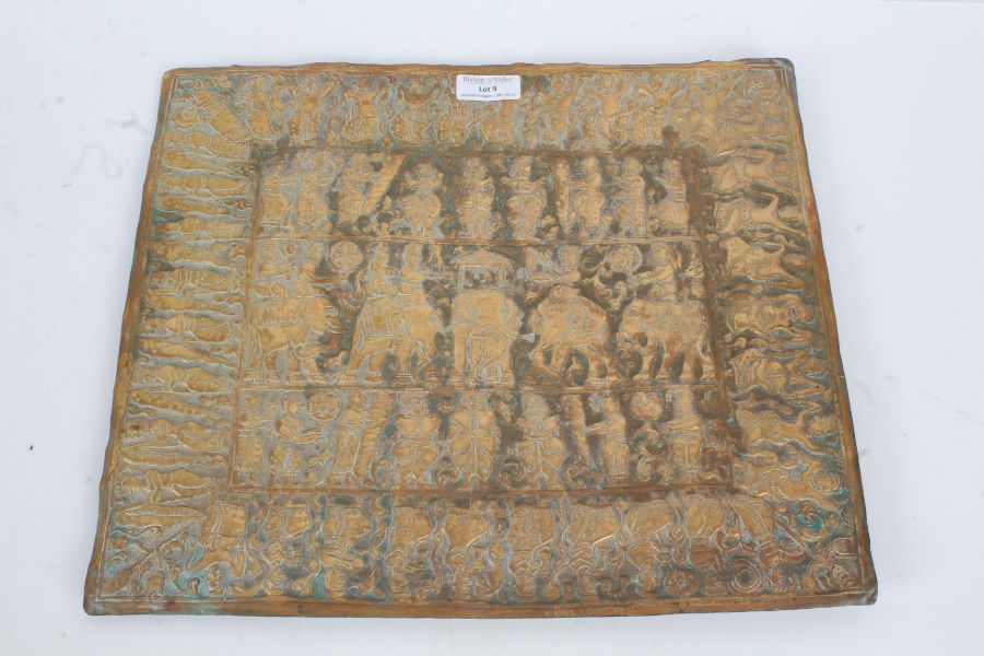 Eastern brass plaque, embossed with figures riding elephants, 35.5cm wide, 30.5cm high