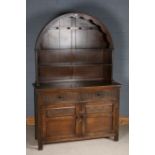 17th century style oak dresser and rack, with an arched rack above the cupboard base with thumb