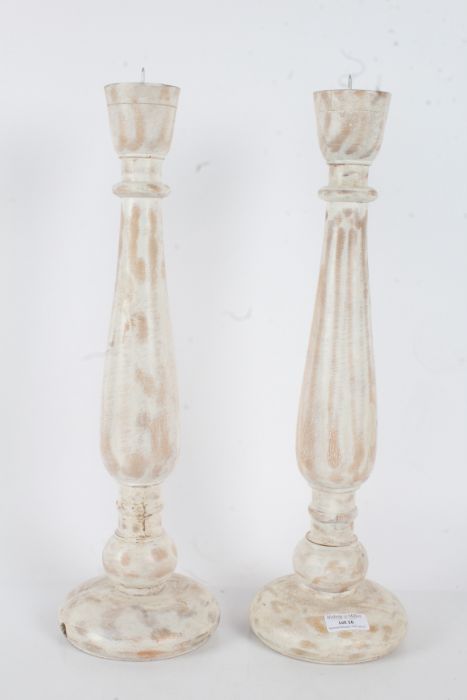 Pair of white painted wooden picket candlesticks, with a turned baluster form stem raised on a