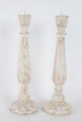 Pair of white painted wooden picket candlesticks, with a turned baluster form stem raised on a