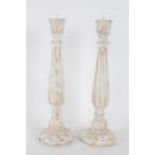 Pair of white painted wooden picket candlesticks, with a turned baluster form stem raised on a