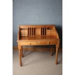 20th century pine desk, with eight drawers and various pigeonholes above turned legs, 110cm wide