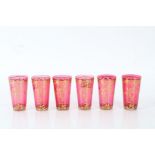 Set of six cranberry glasses with gilt floral decoration, 10cm high