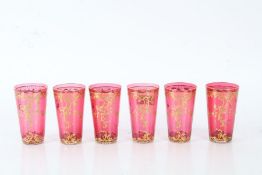 Set of six cranberry glasses with gilt floral decoration, 10cm high