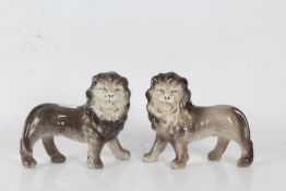 Pair of porcelain lions in grey and white, 22cm long 19cm high