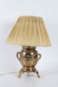 Japanese brass table lamp, having naturalistic branch carrying handles, the body centred with