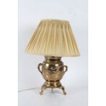 Japanese brass table lamp, having naturalistic branch carrying handles, the body centred with