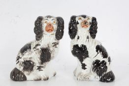 Near pair of Staffordshire spaniels, in black and white, 15cm tall (2)