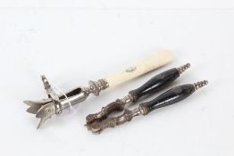 Bone handled and plated meat carving clamp, the handle with mother of pearl inlay, and a pair of