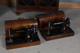 Two Singer sowing machines, both housed within wooden case