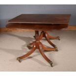 George III twin pillar oak D-end extending dining table, raised on eight out swept legs and brass