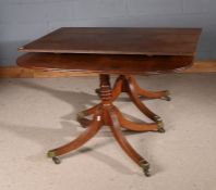 George III twin pillar oak D-end extending dining table, raised on eight out swept legs and brass