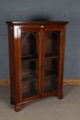 Late Victorian mahogany bookcase, with dental moulding above a pair of Gothic revival glazed