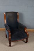 Victorian mahogany deep seated armchair, with blue upholstery and raised on knopped tapering legs