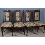 Set of four upholstered dining chairs, with an arched pediment above floral upholstered back and