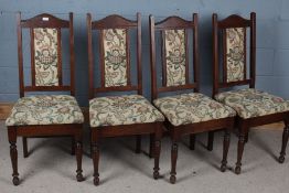 Set of four upholstered dining chairs, with an arched pediment above floral upholstered back and