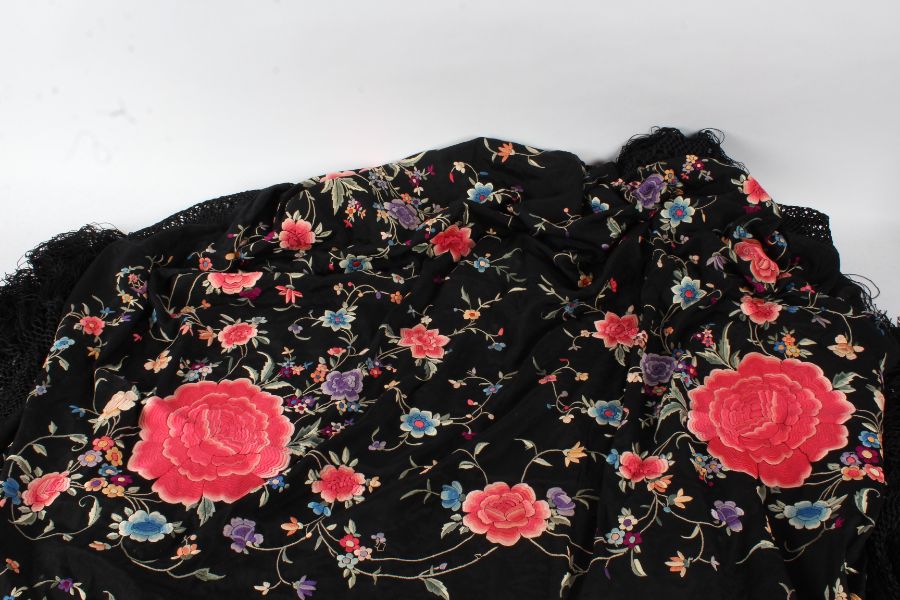Large Victorian shawl, the black ground with with brightly coloured flowers with tassels to the ends