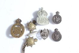 A First World War 'On War Service' badge dated 1915, serial number 32780 to reverse, together with