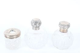 Two silver lidded clear glass scent bottles and a silver lidded clear glass hair pin tidy (3)