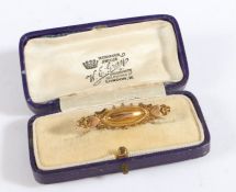 A 9 carat gold bar brooch, with hearts to each end and a center with an oval design, weight 1.4