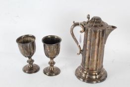 Silver plated communion wine jug and pair of goblets, the jug with domed lid and scrolled