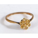 A yellow metal ring with a flower shaped head set two pearls, ring size M weight 1.3 grams