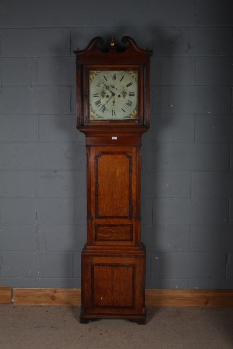 A Victorian longcase clock, with a scroll pediment and a brass finial, with a painted white dial