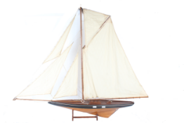 A large 20th century wooden pond yacht, with a single mast, weighted hull, canvas sails, rigging set