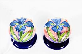 A pair of Moorcroft style tube line decorated porcelain door knobs, the dark blue ground decorated